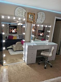 a bedroom with a vanity, mirror and lights