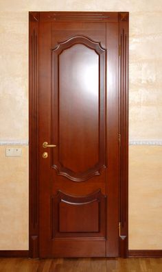 a wooden door in an empty room