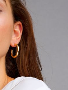 "Your new favorite thick hoops, these hoops are the perfect size. Thick and bold, surely to make the perfect statement. At a medium size these simple gold hoops can be for everyday or special occasions. DETAILS: All hoops are sold in pairs. Open Medium Diameter: 32mm Width: 4mm Open Classic Hoops Diameter: 44.5mm Width: 4mm QUALITY: * 100% 14k Gold Vermeil or Sterling Silver available What is 14k Gold Vermeil? We thought you would ask! :) 14k Gold Vermeil (pronounced \"ver-may\"), should not be Gold Earrings Big, Simple Gold Hoops, Catherine Paiz, Red Earrings Stud, Weave Ponytail, 14k Gold Hoop Earrings, Front Back Earrings, Spiral Earrings, Hoops Earrings