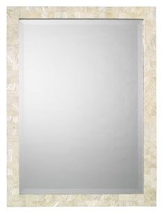 a square mirror with white frame