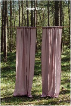 two pink curtains hanging from a clothes line in the woods with text overlay that reads,