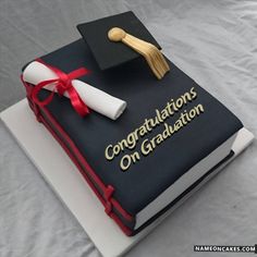 a graduation cake with a mortar and diploma on it's cover that says congratulations on graduation