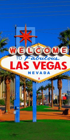 the welcome to las vegas sign in front of palm trees