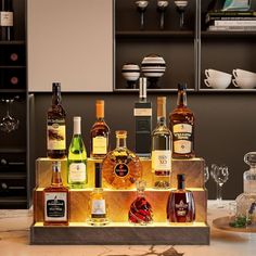 an assortment of liquor bottles on display in a kitchen