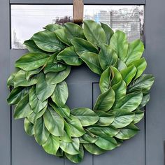 a green wreath hanging on the front door