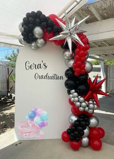 balloon arch with star and balloons for graduation party at the back drop off area in front of gazebo