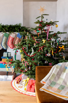 a christmas tree with stockings hanging from it