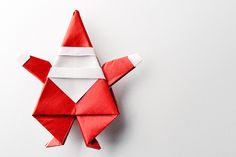 an origami red bird on a white background