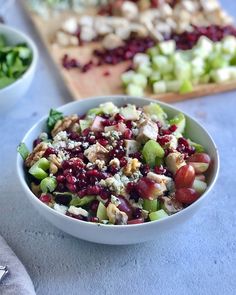 two bowls filled with food sitting on top of a table next to chopping boards