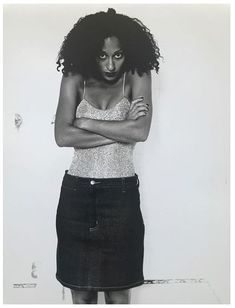 a black and white photo of a woman with her arms crossed in front of her face