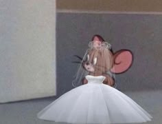 a doll in a white dress with a pink mouse on it's head is shown