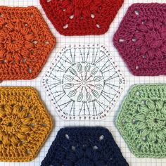 four crocheted hexagons are arranged on a sheet of graph paper