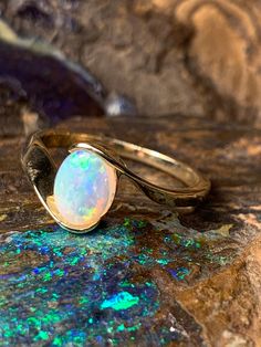 🔥 DESCRIPTION Handcrafted to deliver results of unsurpassed quality, this ring will serve as a lasting memory and a connection to the one you love. In addition to its minimalist style, the brilliant opal at its center makes this ring look beyond comparison, drawing attention from every angle. Finished with a smooth fine gold frame, this ring will certainly fit your style.  Key Features:  ●Colourful Oval Shape Australian Crystal Opal ●Oval Ring ●9 Karat Gold  ●Fast Shipping ●Limited Availability  Specifications:  ●Total Weight: 1.95g ●Opal size: 7x5mm Made with love all the way from Australia  P.S. All our ring can be resized, If you require a different ring size which is not on the list. please select the option at checkout or email me. I would be happy to accommodate your need.  🔥 W H Y Classic Opal Rings With Birthstone, Fine Jewelry Stackable Opal Promise Ring, Stackable Opal Promise Ring In Fine Jewelry Style, Stackable Bypass Ring For Promises, Stackable Yellow Gold Opal Ring For Anniversary, Stackable Opal Ring In Yellow Gold For Anniversary, Adjustable Yellow Gold Opal Ring For Anniversary, Adjustable Oval Opal Ring In 14k Gold, Adjustable 14k Gold Oval Opal Ring