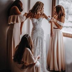 bridesmaids helping the bride get ready for her wedding