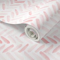 a pink and white wallpaper with watercolor strokes on it's paper roll