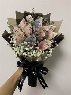 a bouquet of flowers is wrapped in black ribbon