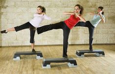 three people are doing yoga on their own stands