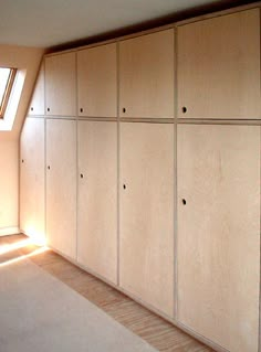 an empty room with wooden cabinets in it