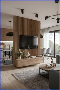 a modern living room with wood paneling and large tv mounted on the wall above it