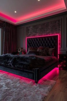 a large bed with pink lights on the headboard and foot board in a bedroom