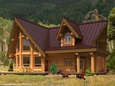 a small log cabin house with a red metal roof