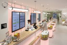 two people standing at the counter in a store