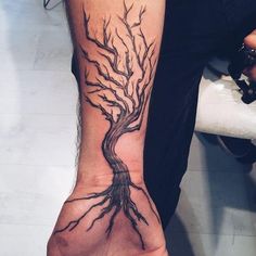 a person with a tree tattoo on their arm