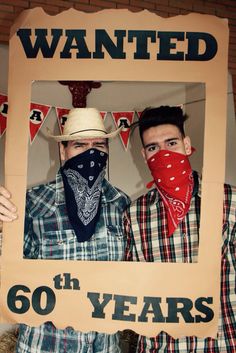 two men in cowboy hats and bandanas holding up a sign that says, wanted 60 years