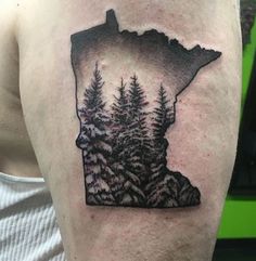 a man with a tattoo on his arm that has trees in the shape of minnesota