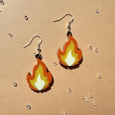 Each earring is made of acrylic and attached to stainless steel, hypoallergenic ear wires. Each pair comes with a rubber earring back. Measures 2" long. Acrylic Earrings Laser Cut, Fire Theme, Fire Emoji, Erie Pa, Gender Envy, Earring Ideas, Etsy Earrings Dangle, Acrylic Earrings, Diy Earrings