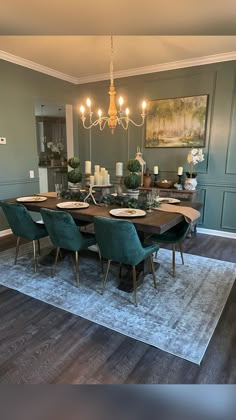 the dining room table is set with green chairs and place settings for four people to sit at