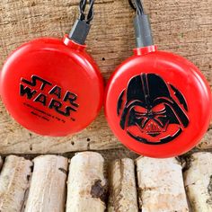 two frisbees with darth vader faces on them hanging from chains