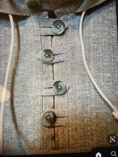 a close up of a buttoned shirt with buttons on the front and back side