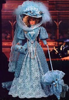 an old fashion doll in blue dress and bonnet with umbrella on the cover of a magazine