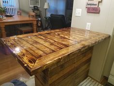 a kitchen island made out of wooden planks