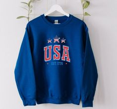 "\"Believe in the American Dream.\" USA Flag Sweatshirt, Patriotic Sweat,  🕕Production Time 1-3 business day🕕 ➡️𝗛𝗢𝗪 𝗧𝗢 𝗢𝗥𝗗𝗘𝗥 ⬅️ 𝟏. Please, Check and Review all Photos. 𝟐. Select Your Sweatshirt / Hoodie Size and  Color from drop down menus. 𝟑. Enter your Design Color. 𝟒. Choose Your Quantity as much as you want. 𝟒. Click 𝗔𝗗𝗗 𝗧𝗢 𝗖𝗔𝗥𝗧. For multiple items go back to the listing and repeat the steps. 📏𝐒𝐈𝐙𝐈𝐍𝐆 𝗔𝗡𝗗 𝐂𝐎𝐋𝐎𝐑𝐒 📚 For detailed sizing information and Patriotic Long Sleeve Sweatshirt For Independence Day, Patriotic Long Sleeve Winter Sweater, American Flag Sweatshirt, Usa Hoodie, Star Hoodie, Occupational Therapy Shirts, Usa Sweatshirt, The American Dream, Funny Christmas Shirts