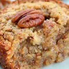 a close up of a piece of cake on a plate with pecans in the middle