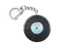 an old record keychain with the word disco on it's front side