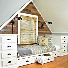 a bed with drawers underneath it and a window in the top half of the room