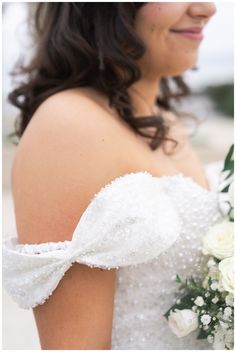 a woman in a wedding dress holding a bouquet