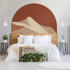 a bed with white sheets and pillows next to a wooden headboard in a bedroom