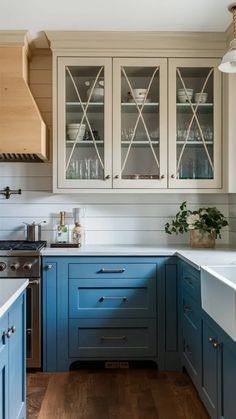 a kitchen with blue cabinets and wooden floors