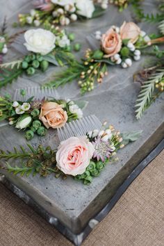 flowers and greenery are laid out on a tray