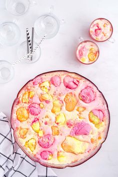 a pizza sitting on top of a table next to glasses and napkins with confetti