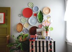 a room with plates and plants on the wall