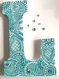 the letter j is decorated with paisley designs