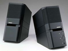 two black speakers sitting next to each other