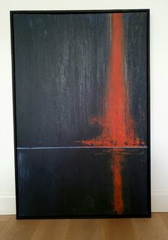 an abstract painting with orange and black colors on a white wall next to a wooden floor