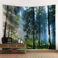 a room with a wooden floor and a wall hanging on the wall is decorated with an image of a forest