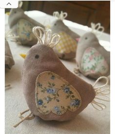 small stuffed birds sitting on top of a table